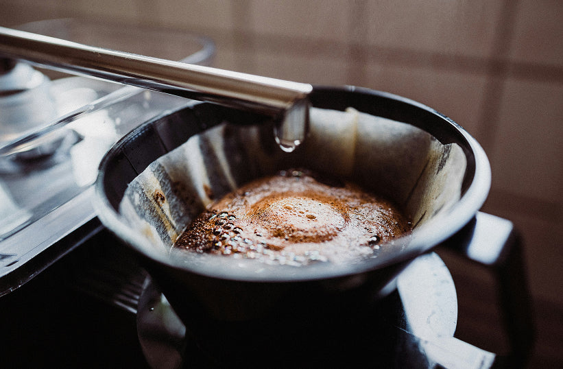 Drip coffee brewing through a filter into a glass carafe - Seattle Coffee Gear