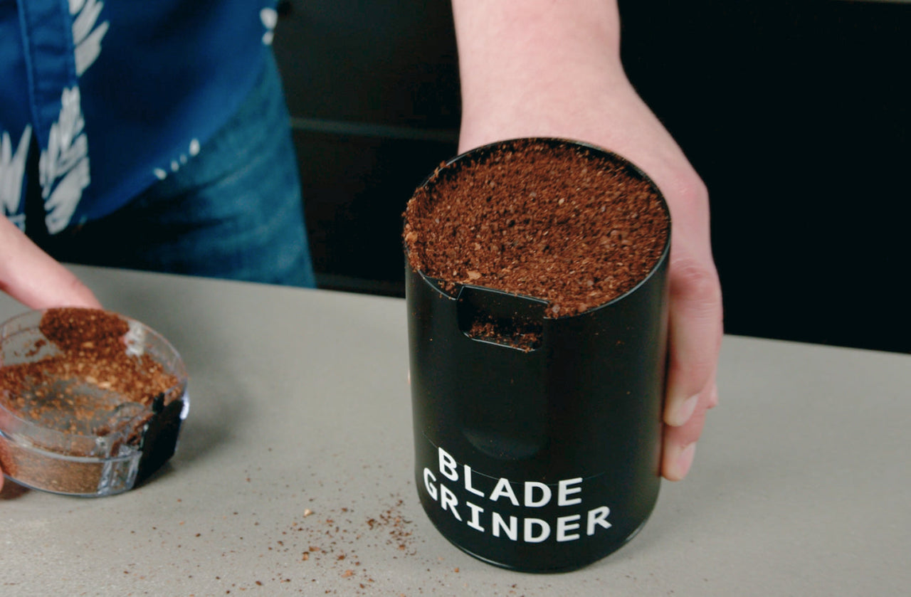 Blade grinder filled with unevenly ground coffee, showing inconsistent grind size