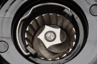 Conical burr set inside a coffee grinder grinding chamber, viewed from above