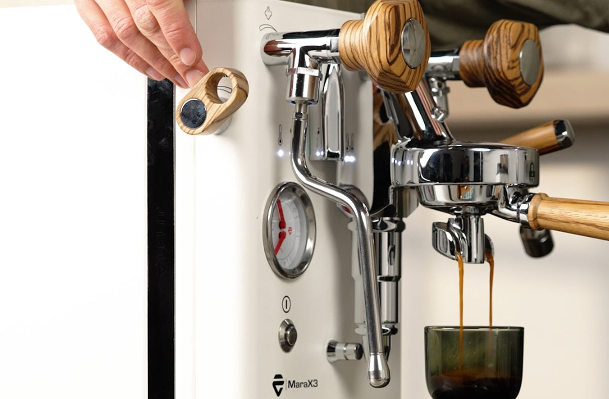 LELIT Mara X3 pulling espresso while a hand adjusts the Pagaia flow profiling paddle - Seattle Coffee Gear