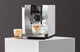 Jura Z10 superautomatic espresso machine brewing a latte macchiato on a countertop