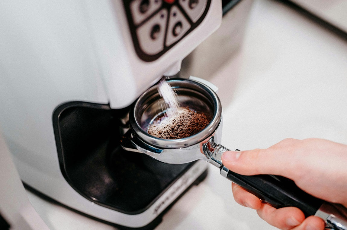 Coffee grinding into portafiliter - Photo by Charles Sims for Unsplash